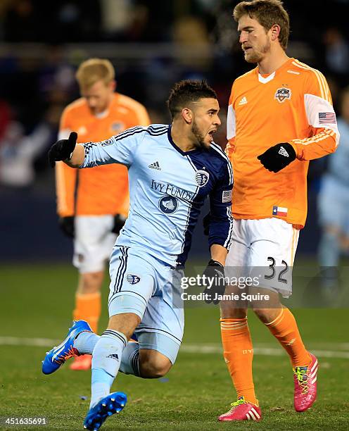 Dom Dwyer of the Sporting KC celebrates after scoring the game-winning goal as Bobby Boswell of the Houston Dynamo looks down during Leg 2 of the...