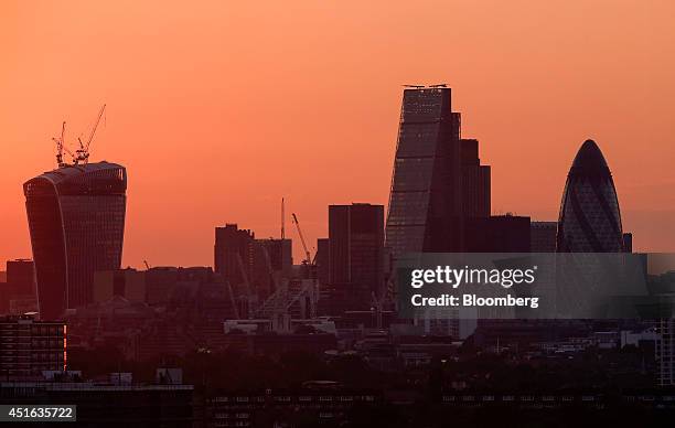 The evening sun turns the summer sky red behind 20 Fenchurch Street, also known as the 'Walkie-Talkie,' left, the Leadenhall building, also known as...