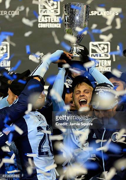 Seth Sinovic of Sporting KC celebrates with the trophy after Sporting KC defeated the Houston Dynamo to win the Eastern Conference Championship at...