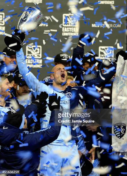 Aurelien Collin of Sporting KC celebrates with the trophy after Sporting KC defeated the Houston Dynamo to win the Eastern Conference Championship at...