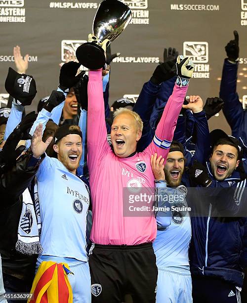 Captain Jimmy Nielsen of the Sporting KC hoists the trophy with teammates after Sporting KC defeated the Houston Dynamo to win the Eastern Conference...