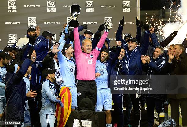 Captain Jimmy Nielsen of the Sporting KC hoists the trophy with teammates after Sporting KC defeated the Houston Dynamo to win the Eastern Conference...