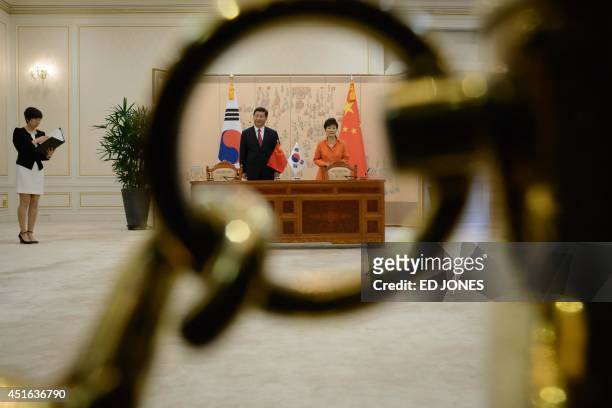 China's President Xi Jinping and South Korean President Park Geun-Hye attend a signing ceremony following summit meeting at the Blue House in Seoul...