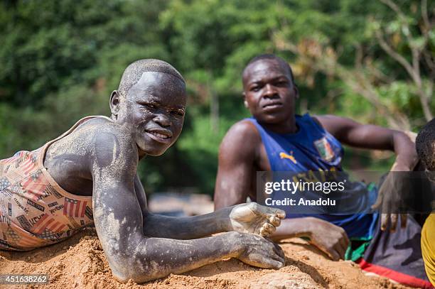 Gold miners pose in Ndassima gold mine, 40 Km of Bambari, in Seleka group controlled zone, in the Eastern part of CAR. Independent gold panners run...