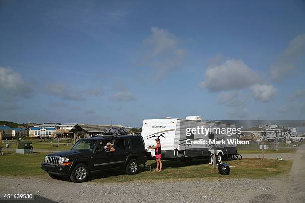 Carissa Phillips of Gettysburg Pa. Directs her husband Joe Miller as he backs up to hook up their travel trailer at the KOA Capmground to comply with...