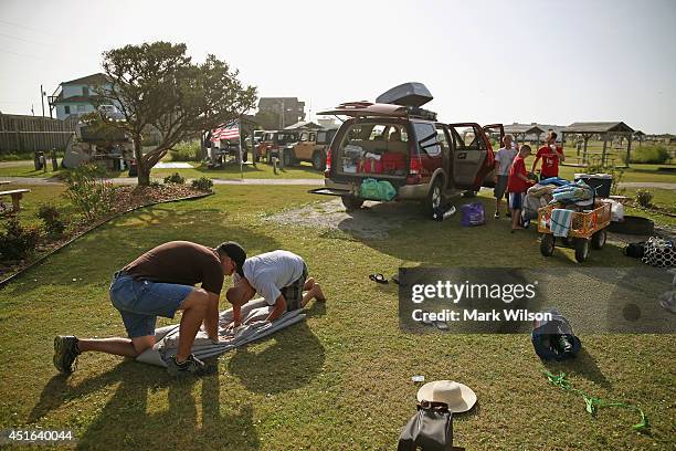 Joey Haywood of Troy, NC. And his son Dawson Haywood fold up the families tent at a campsite before departing the KOA Capmground to comply with the...