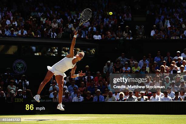 Eugenie Bouchard of Canada serves during her Ladies' Singles semi-final match against Simona Halep of Romania on day ten of the Wimbledon Lawn Tennis...