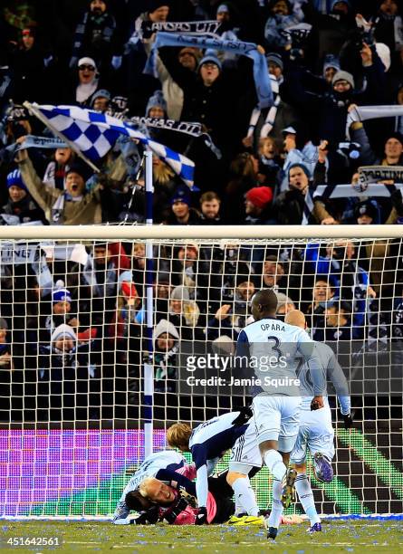 Seth Sinovic and C.J. Sapong jump on top of Jimmy Nielsen of the Sporting KC after Sporting KC defeated the Houston Dynamo 2-1 to win the Eastern...