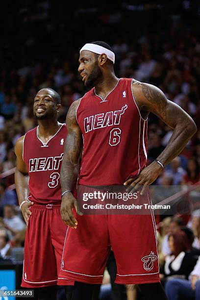 Dwyane Wade of the Miami Heat and LeBron James of the Miami Heat look on during a game against the Orlando Magic at American Airlines Arena on...