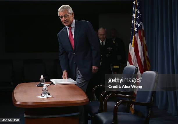 Secretary of Defense Chuck Hagel and Chairman of the Joint Chiefs of Staff Gen. Martin Dempsey arrive at a news briefing July 3, 2014 at the Pentagon...