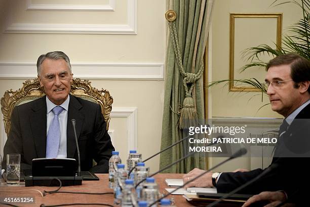 Portugal's President Anibal Cavaco Silva , flanked by Portuguese Prime Minister Pedro Passos Coelho , chairs a state council meeting at the Belem...