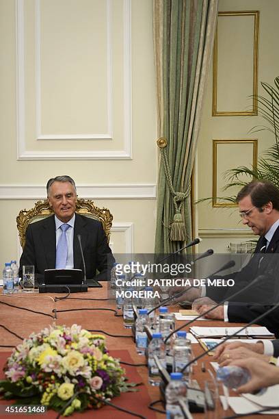 Portugal's President Anibal Cavaco Silva , flanked by Portuguese Prime Minister Pedro Passos Coelho , chairs a state council meeting at the Belem...