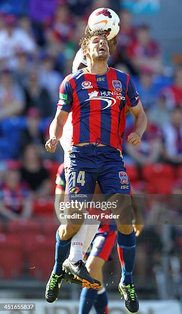 Josh Mitchell of the Jets contests the header against Heart defence during the round seven A-League match between the Newcastle Jets and the...