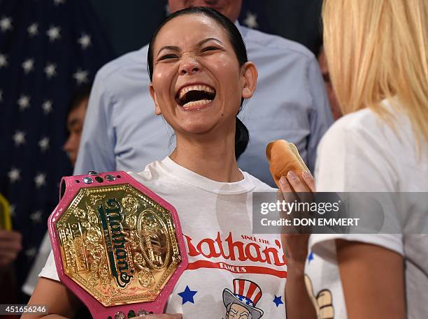 Nathan's Famous hot dog-eating women's champion of 2013, Sonya "The Black Widow" Thomas, laughs during a weigh-in ceremony on July 3, 2014 at City...