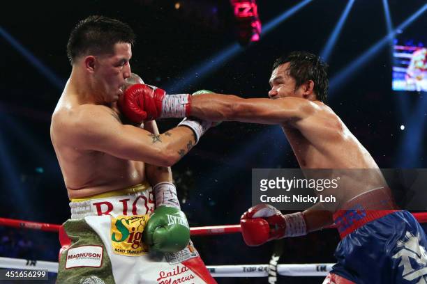 Manny Pacquiao of the Philippines punches Brandon Rios of the U.S. During their 'Clash in Cotai' WBO International Welterweight title fight on...