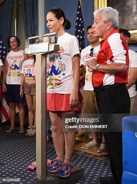 Nathan's Famous hot dog-eating women's champion of 2013, Sonya "The Black Widow" Thomas, is weighed at a ceremony on July 3, 2014 at City Hall in New...