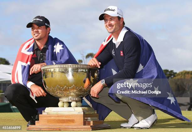 Winners of the pairs Jason Day and Adam Scott of Australia pose with the trophy during day four of the World Cup of Golf at Royal Melbourne Golf...