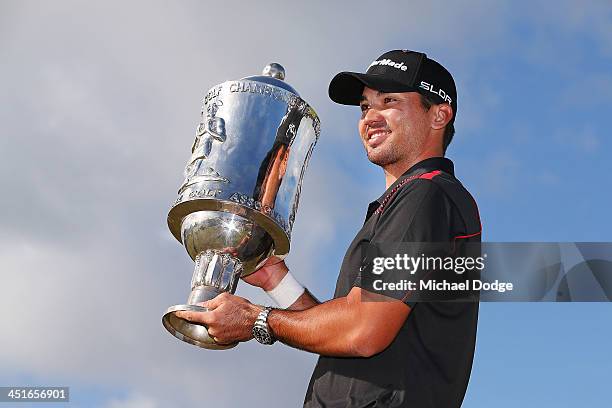 Winners Jason Day of Australia poses with the trophy during day four of the World Cup of Golf at Royal Melbourne Golf Course on November 24, 2013 in...