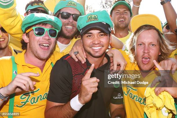 Winner Jason Day of Australia poses with the Fanatics during day four of the World Cup of Golf at Royal Melbourne Golf Course on November 24, 2013 in...