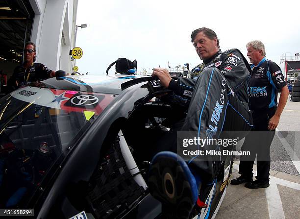 Michael Waltrip, driver of the RoyalTeakCollection.com Toyota, gets out of his car during practice for the NASCAR Sprint Cup Series Coke Zero 400 at...