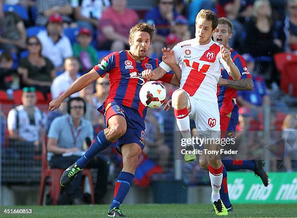 Josh Mitchell of the Jets contests the ball against Hearts defence during the round seven A-League match between the Newcastle Jets and the Melbourne...