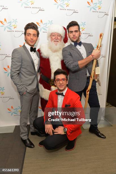 Singers Gianluca Ginoble, Piero Barone and Ignazio Boschetto of Il Vilo pose with Santa Claus backstage at the unveiling of the HGTV Holiday House at...