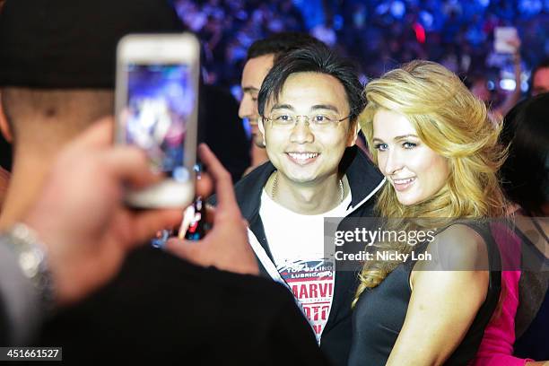 Paris Hilton has a picture taken with a fan as she watches Manny Pacquiao of the Philippines fight with Brandon Rios of the U.S. During the 'Clash in...