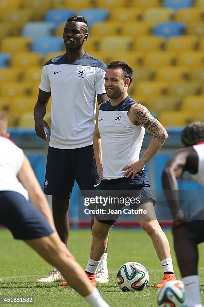 Paul Pogba, Mathieu Valbuena of France warm up during the practice session on the eve of the 2014 FIFA World Cup Brazil Quarter Final match between...