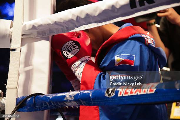 Manny Pacquiao of the Philippines prays before his bout with Brandon Rios of the U.S. During their 'Clash in Cotai' WBO International Welterweight...