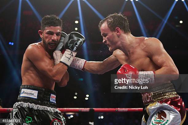 Evgeny Gradovich of Russia fights with Billy Dib of Australia during their 'Clash in Cotai' IBF Featherweight title bout on November 24, 2013 in...