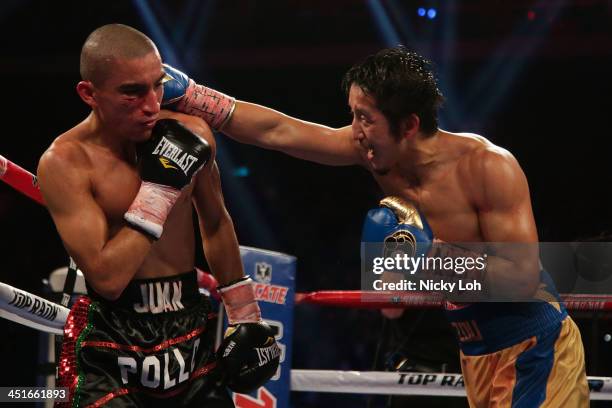 Zou Shiming of China fights with Juan "Pollo" Tozcano of Mexico during their 'Clash in Cotai' flyweight bout on November 24, 2013 in Macau.