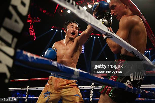 Zou Shiming of China fights with Juan "Pollo" Tozcano of Mexico during their 'Clash in Cotai' flyweight bout on November 24, 2013 in Macau.