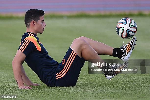 Colombia's midfielder James Rodriguez controls the ball during a training session at Fortaleza's University campus on July 3 the eve of the FIFA...