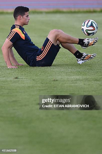 Colombia's midfielder James Rodriguez controls the ball during a training session at Fortaleza's University campus on July 3 the eve of the FIFA...