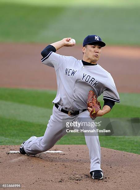 Masahiro Tanaka of the New York Yankees delivers a pitch against the Minnesota Twins during the first inning of the game on July 3, 2014 at Target...