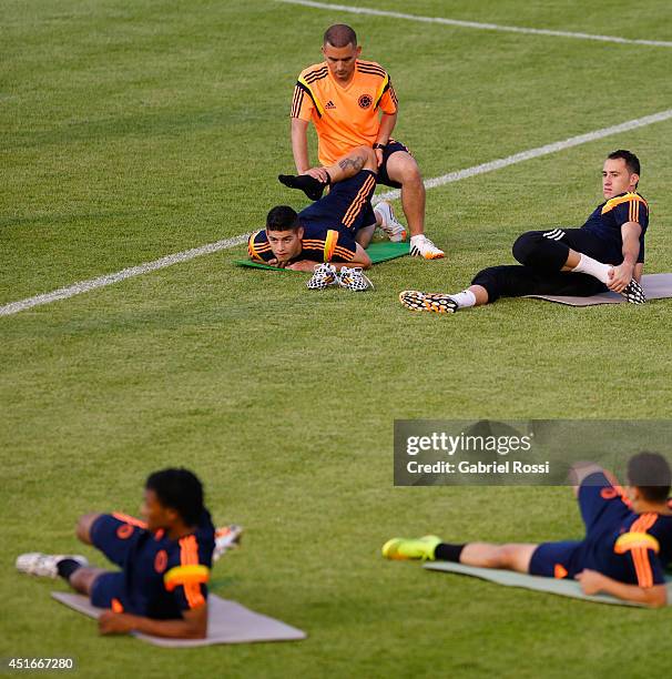 James Rodriguez of Colombia stretch out during a training session at Universidad de Fortaleza Stadium on July 03, 2014 in Fortaleza, Brazil. Colombia...