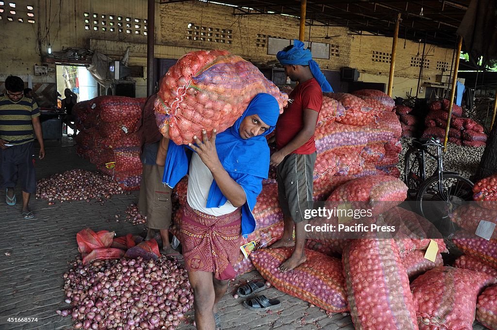 Laborers unloading onion sacks at Mundera wholesale market...