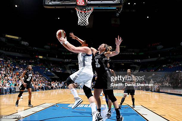 Janel McCarville of the Minnesota Lynx shoots against Jayne Appel of the San Antonio Stars on July 3, 2014 at Target Center in Minneapolis,...