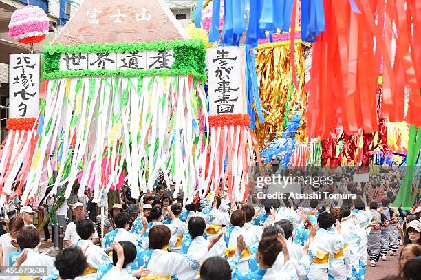 Dancers dressed in traditional costume perform dance under the colorful ornaments of Tanabata during the Shonan Hiratsuka Tanabata Festival on July...