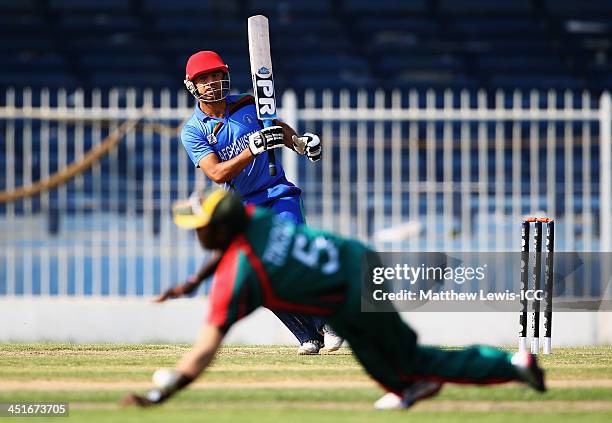 Noor Ali Zadran of Afghanistan hits the ball past Steve Tikolo of Kenya during the ICC World Twenty20 Qualifier between Afghanistan and Kenya at...