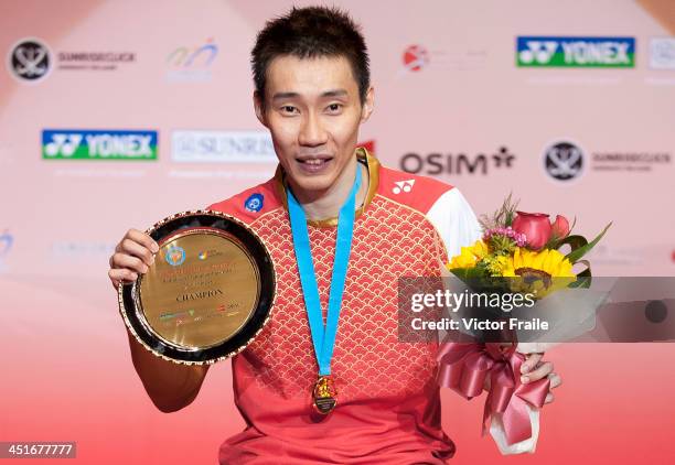 Lee Chong Wei of Malaysia poses with the trophy on the podium after winning the men singles final match against Sony Dwi Kuncoro of Indonesia during...