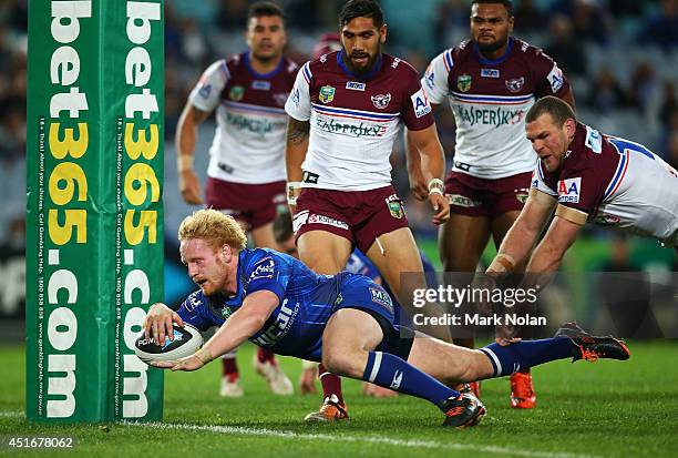 James Graham of the Bulldogs dives over to score a try during the round 17 NRL match between the Canterbury Bulldogs and the Manly Sea Eagles at ANZ...