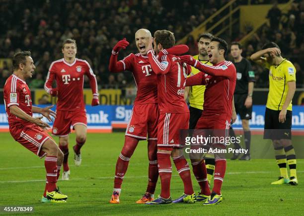 Arjen Robben and Thiago of FC Bayern congratulate Mario Gotze of FC Bayern after his goal during the Bundesliga match between FC Bayern and Bor....