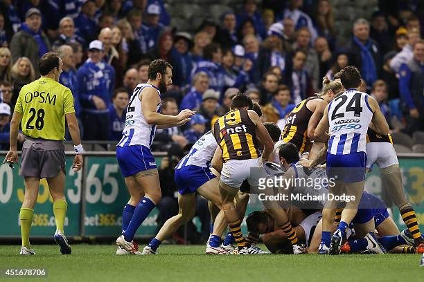 Melee breaks out after Brian Lake of the Hawks and Drew Petrie of the Kangaroos wrestled behind play during the round 16 AFL match between North...