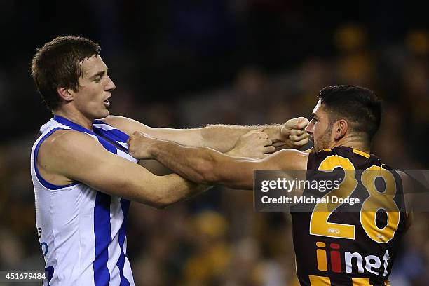 Shaun Atley of the Kangaroos and Paul Puopolo of the Hawks wrestle behind play during the round 16 AFL match between North Melbourne Kangaroos and...