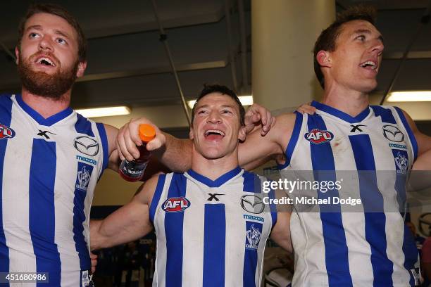 Lachlan Hansen Brent Harvey and Drew Petrie of the Kangaroos celebrate their win during the round 16 AFL match between North Melbourne Kangaroos and...