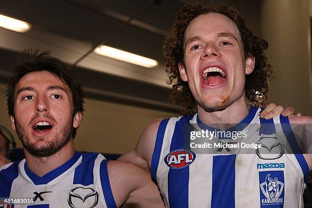 Sam Wright and Ben Brown of the Kangaroos celebrate their win during the round 16 AFL match between North Melbourne Kangaroos and the Hawthorn Hawks...