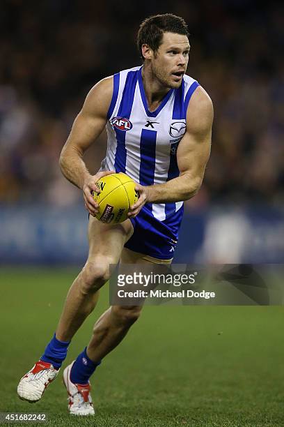 Sam Gibson of the Kangaroos looks upfield during the round 16 AFL match between North Melbourne Kangaroos and the Hawthorn Hawks at Etihad Stadium on...