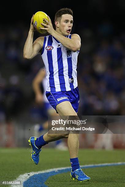 Ryan Bastinac of the Kangaroos gathers the ball during the round 16 AFL match between North Melbourne Kangaroos and the Hawthorn Hawks at Etihad...