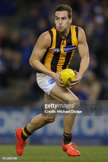 Matt Suckling of the Hawks runs with the ball during the round 16 AFL match between North Melbourne Kangaroos and the Hawthorn Hawks at Etihad...